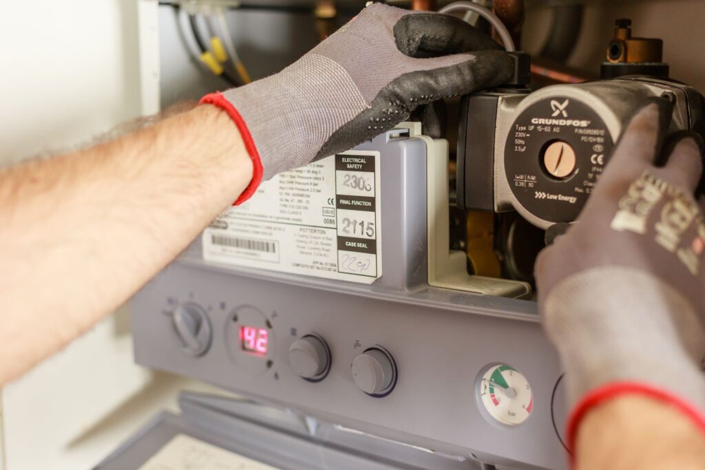 Technician adjusting a home heating system