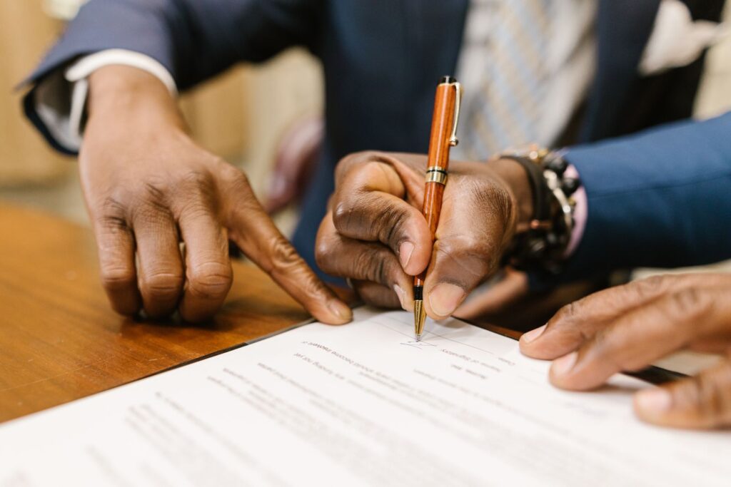 Business owners signing registration documents at a desk