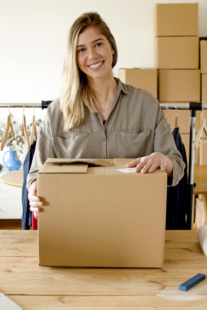 Woman holding a package ready to ship from her online store